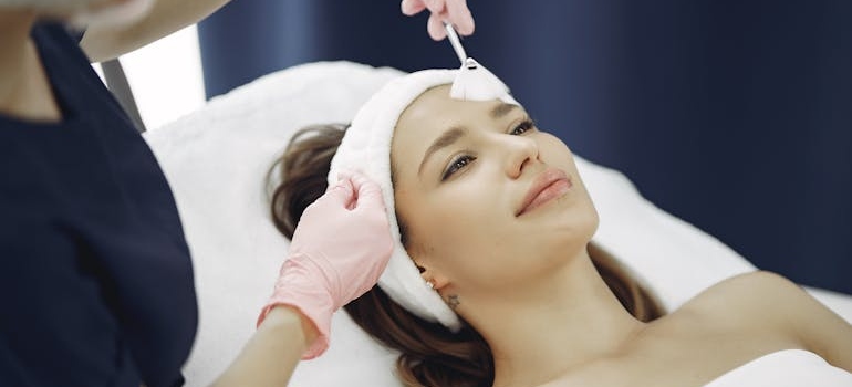 A doctor applying a chemical peel to a patient's skin.






