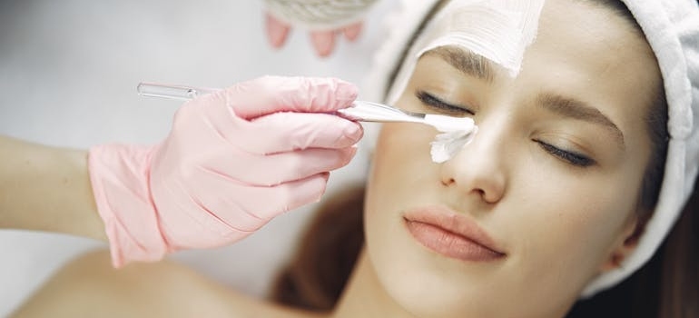 A person applying a chemical peel to their face.






