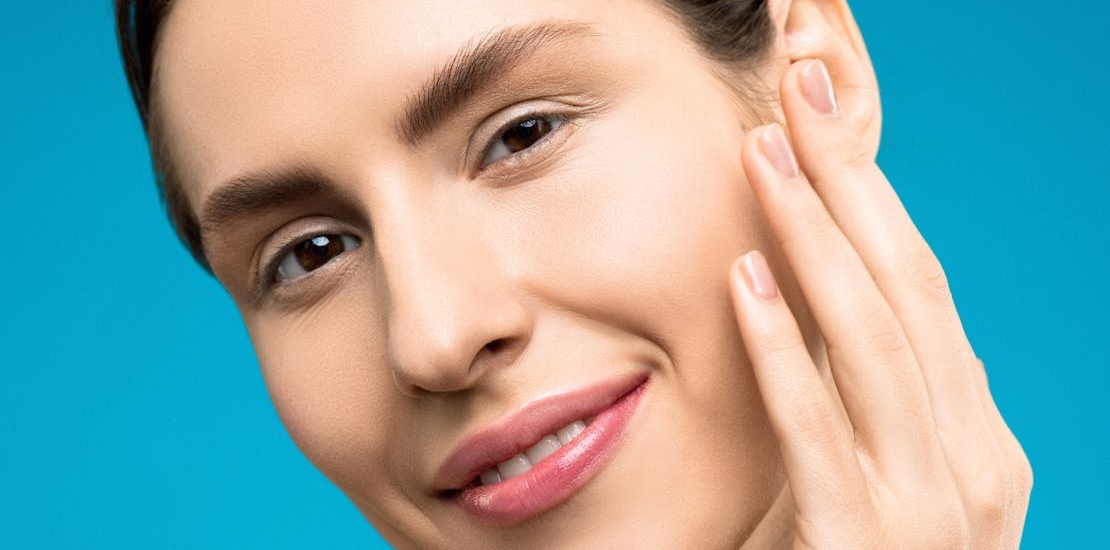 A woman smiling while asking about the different types of chemical peels.
