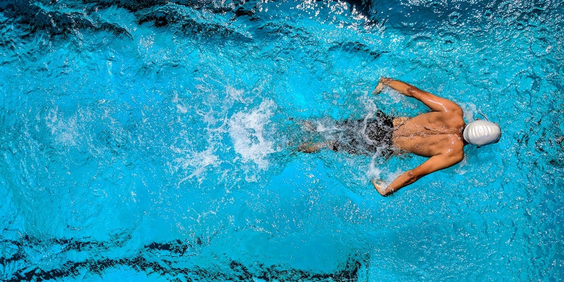 A person swimming in a pool can experience issues such as ear pain.