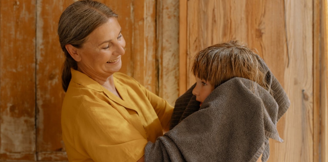 a grandmother drying a child’s hair