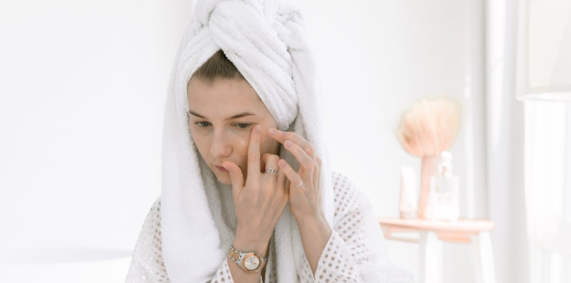 a girl applying a face mask, thinking about how not all dark circles are the same