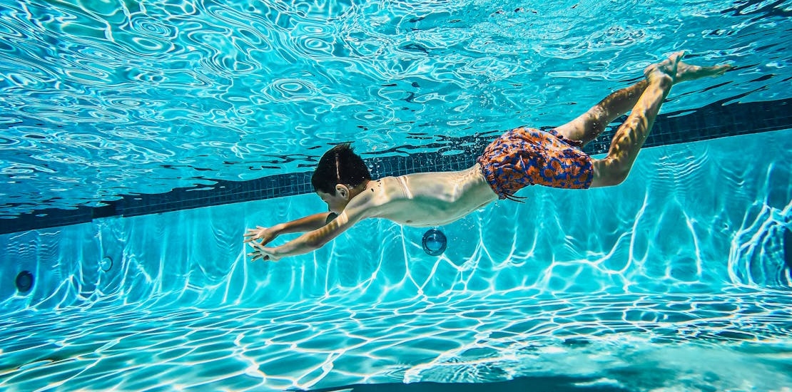 A boy swimming in a pool
