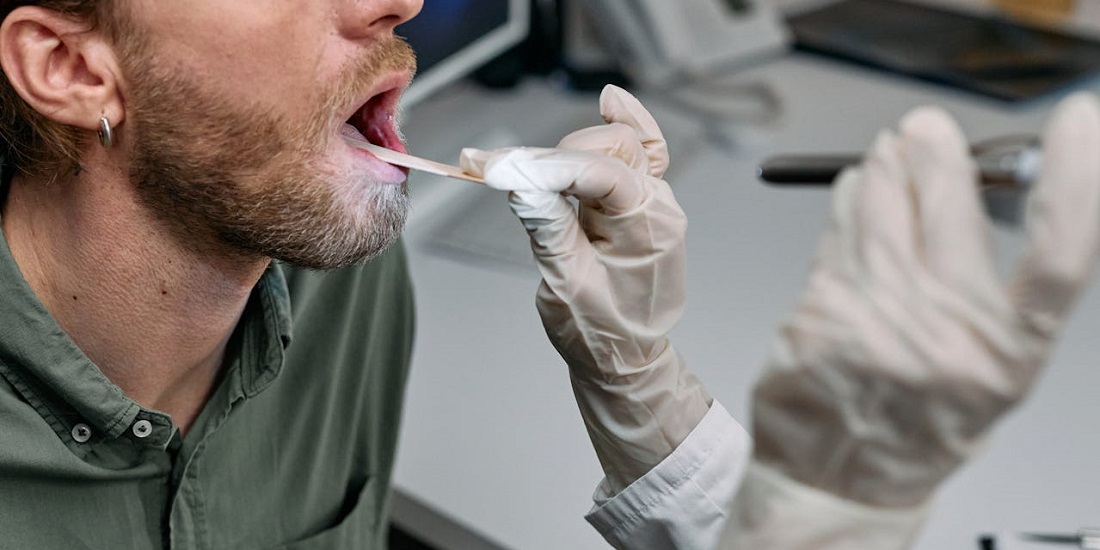 Muškarac tokom osnovnog ORL pregleda grla