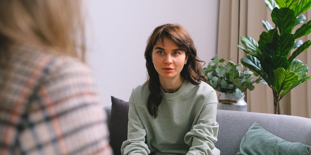 A person who has received a cochlear implant is talking with a speech therapist.