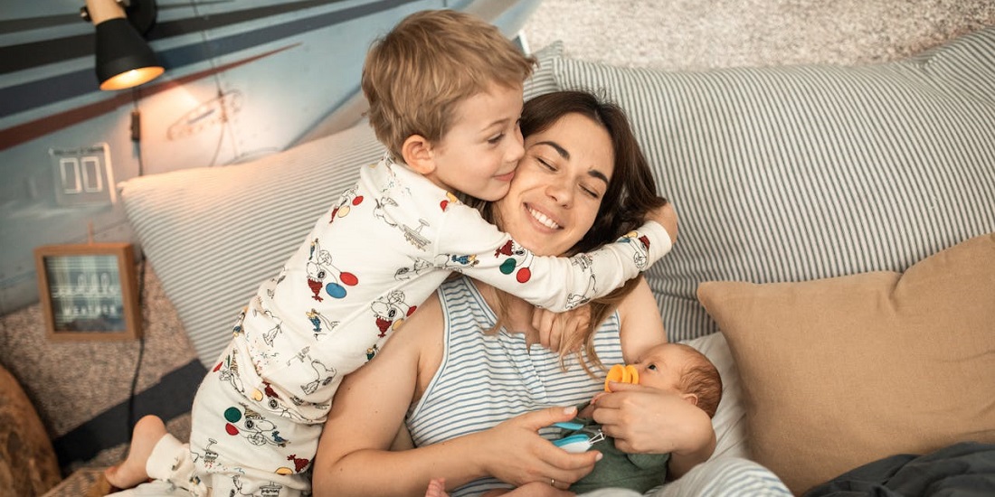 Children snore at night, and their mother soothes them with a smile.