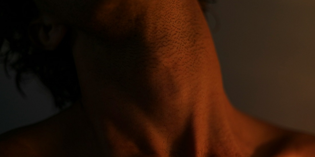 muški vrat u polumraku