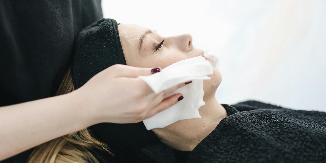 doktorka radi agresivan tretman lica na koži pacijentkinje 