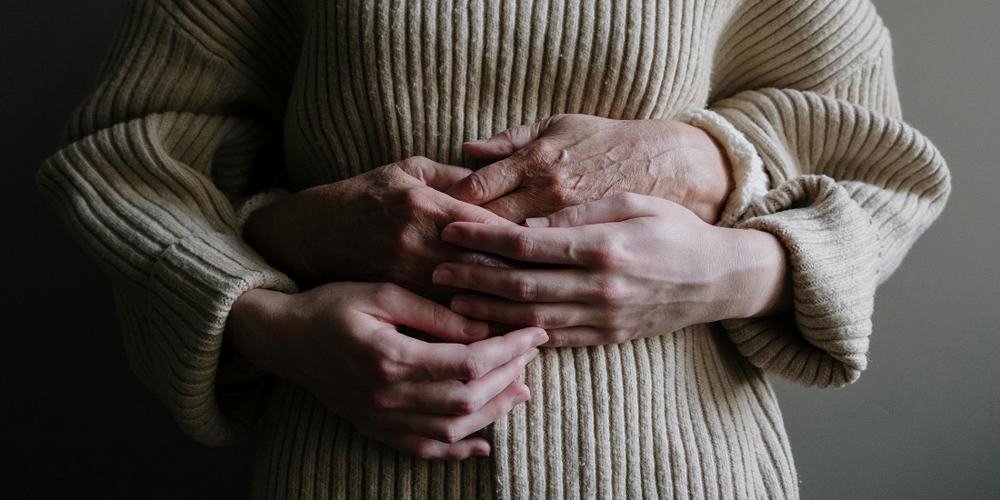 Two hands holding each other.