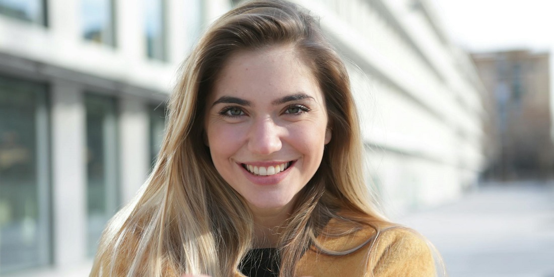 A smiling woman with healthy skin improved by medical grade products.