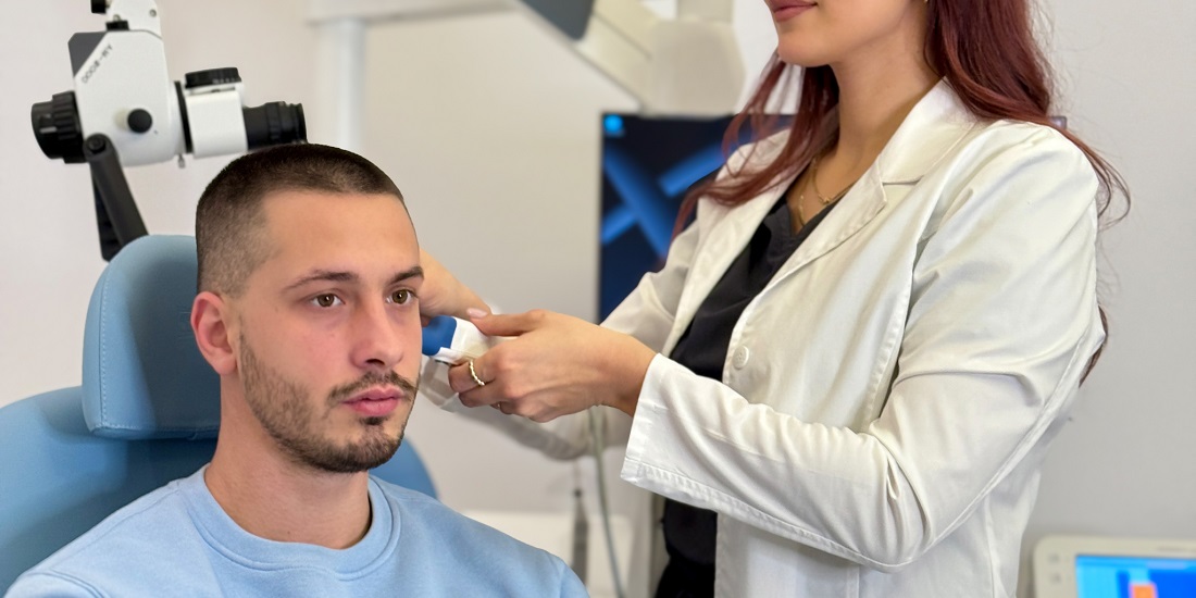 An ENT doctor examines a patient’s ear in the clinic.