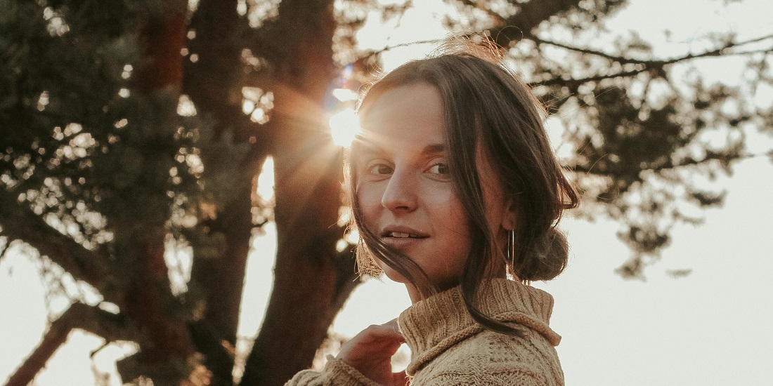 Smiling woman in the sun who needs collagen supplementation.