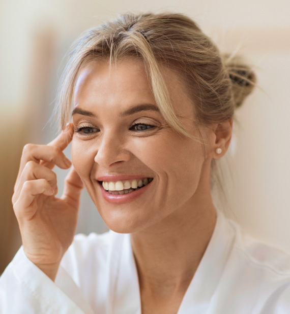 woman looking at her face