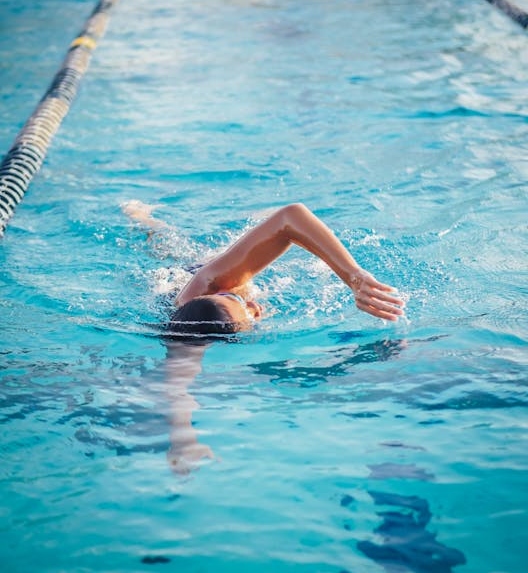 A boy is swimming in a pool