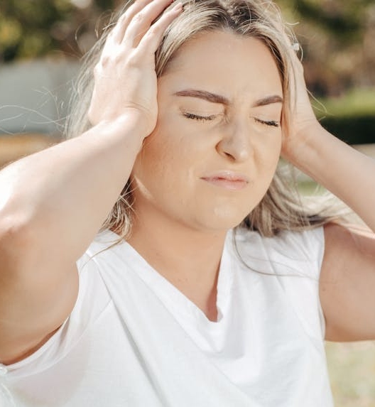 a woman experiencing severe ear pain
