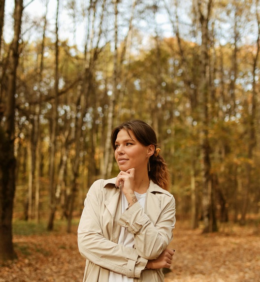 A woman walking in the forest during autumn